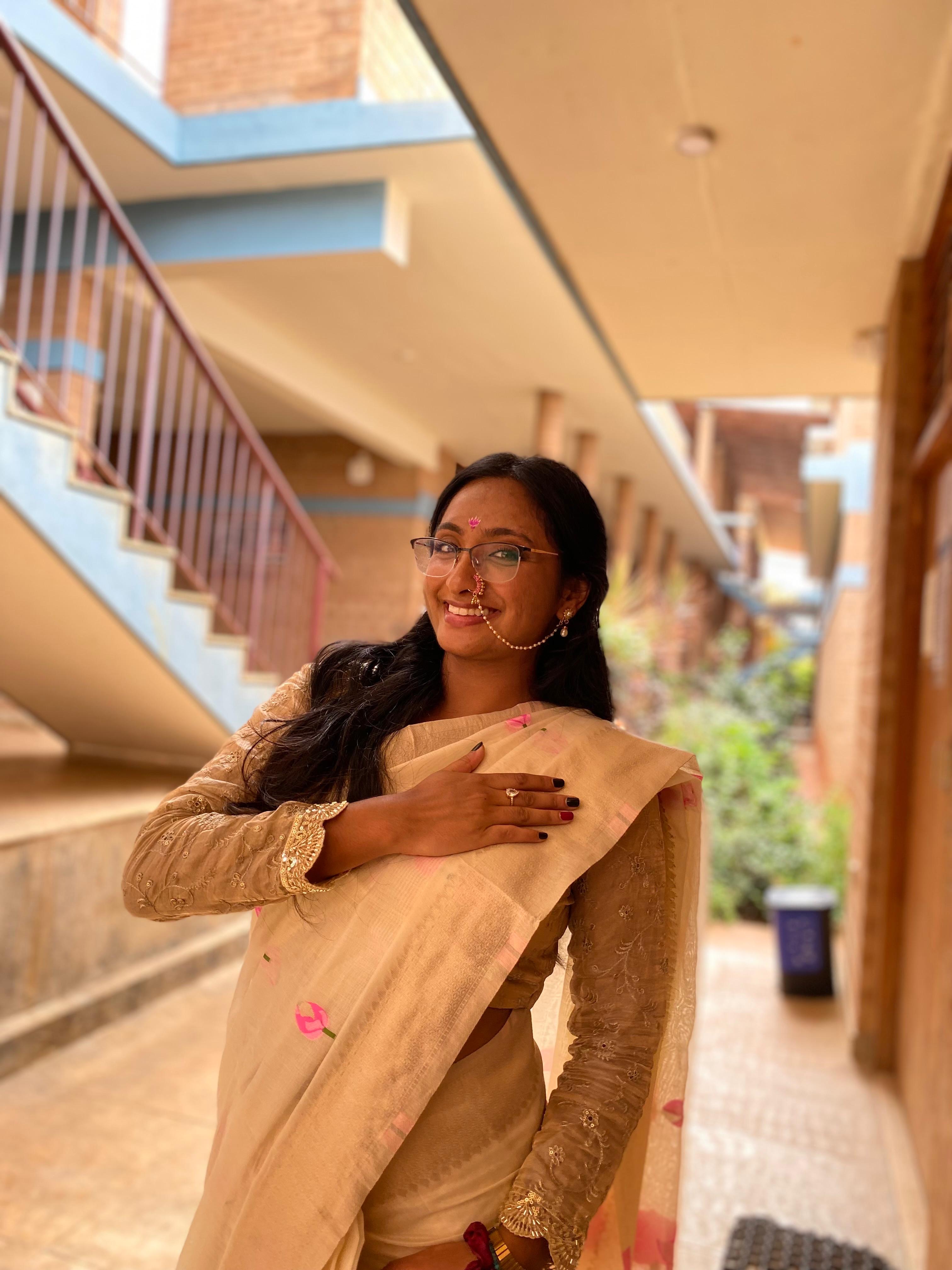 Priyanka, the creator of Worcester Events, smiling in a cream sari